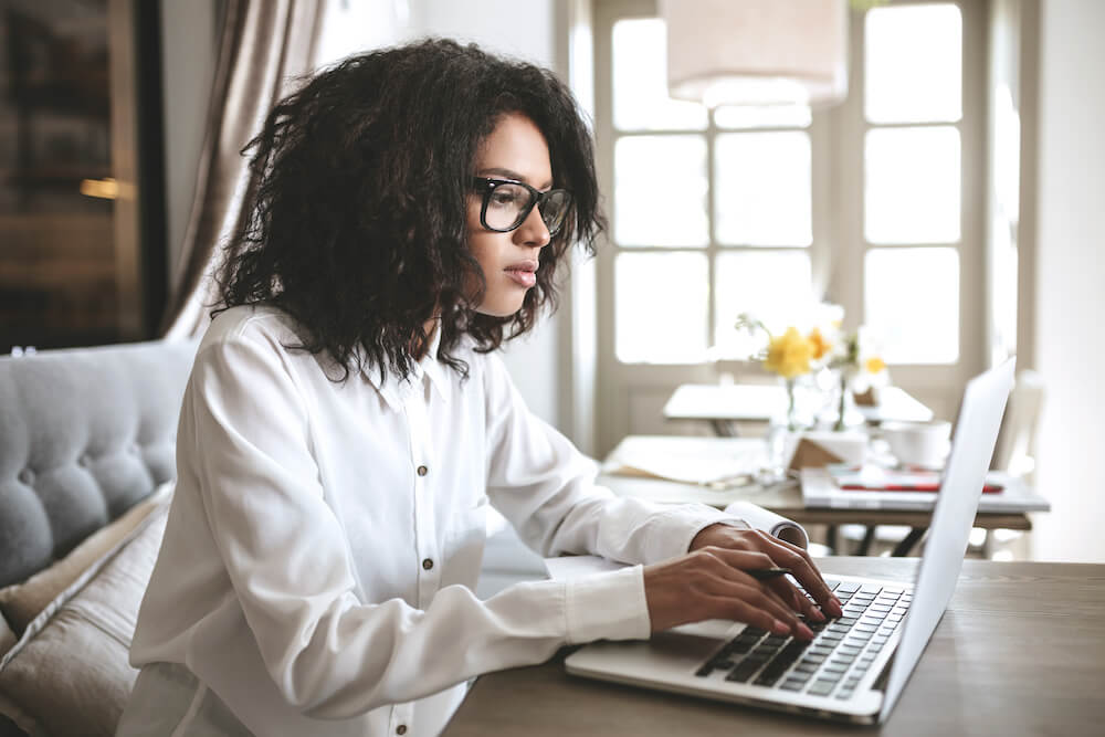 Student sitting at the computer working on their letter of continued interest