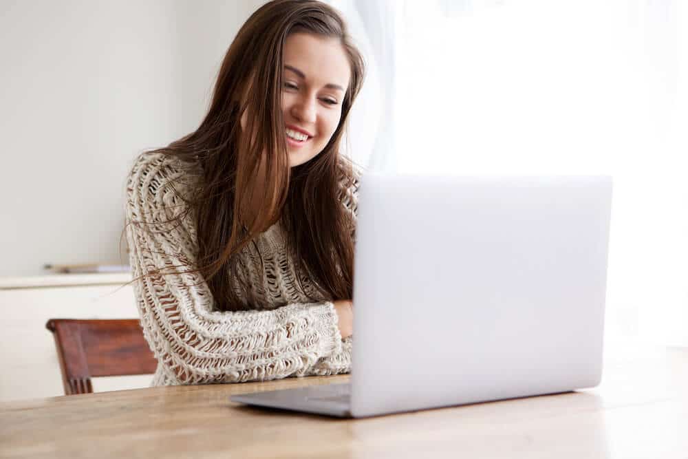 High School Student working at the computer submitting their college application early