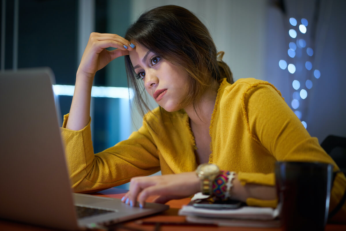 college student looking frustrated looking at their computer screen