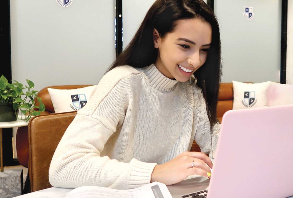 Student looking at their laptop during a successful session of online learning