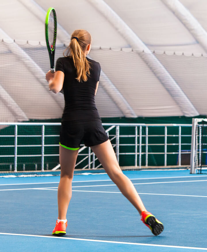 High School Student playing tennis