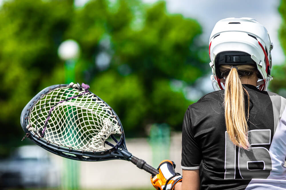 Back of head view of a student during a lacrosse game | Command Education