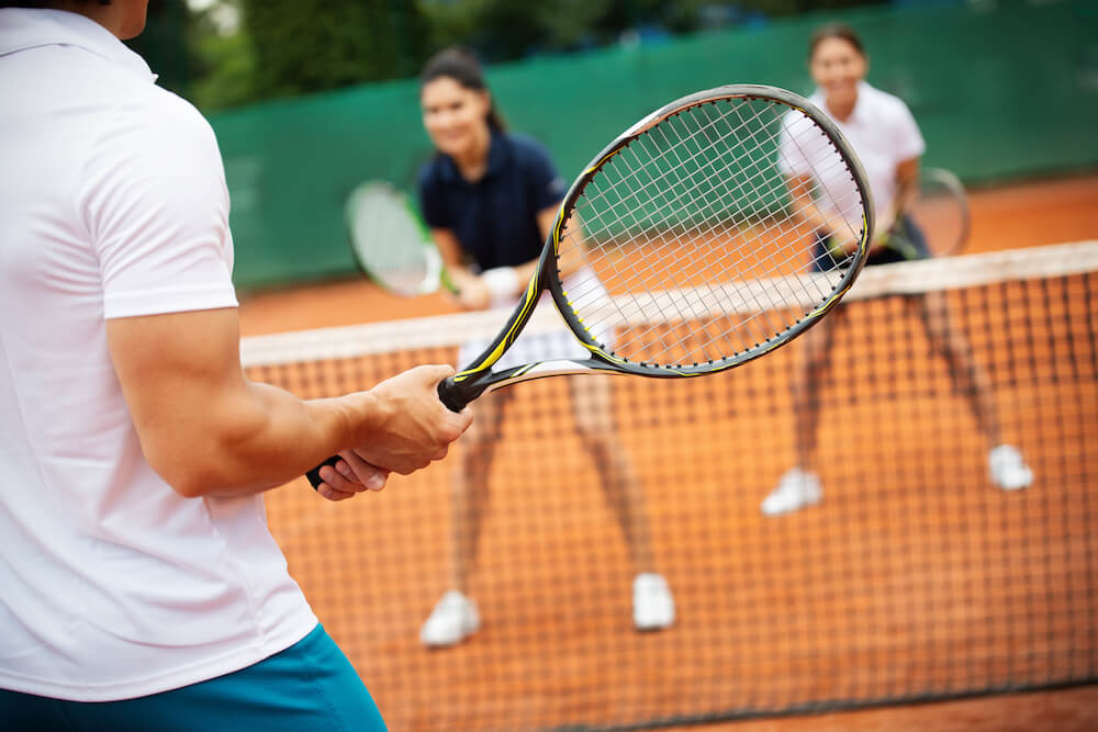 3 students on a tennis court about to play a game | Command Education
