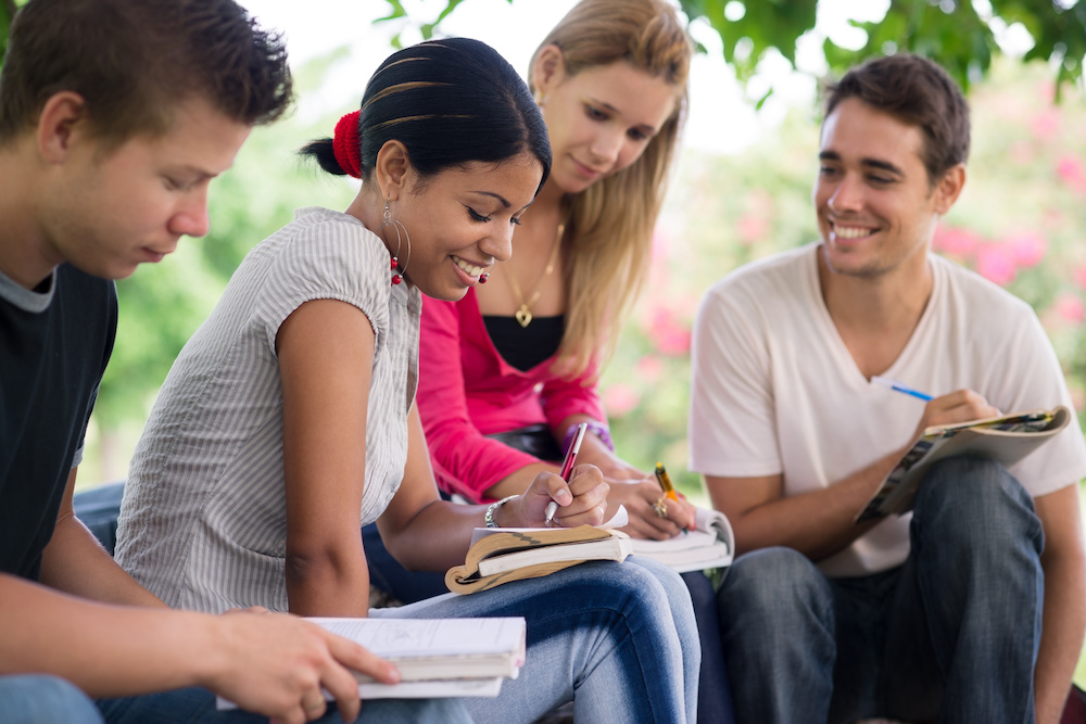 Friends and education, group of university students studying, reviewing homework and preparing test