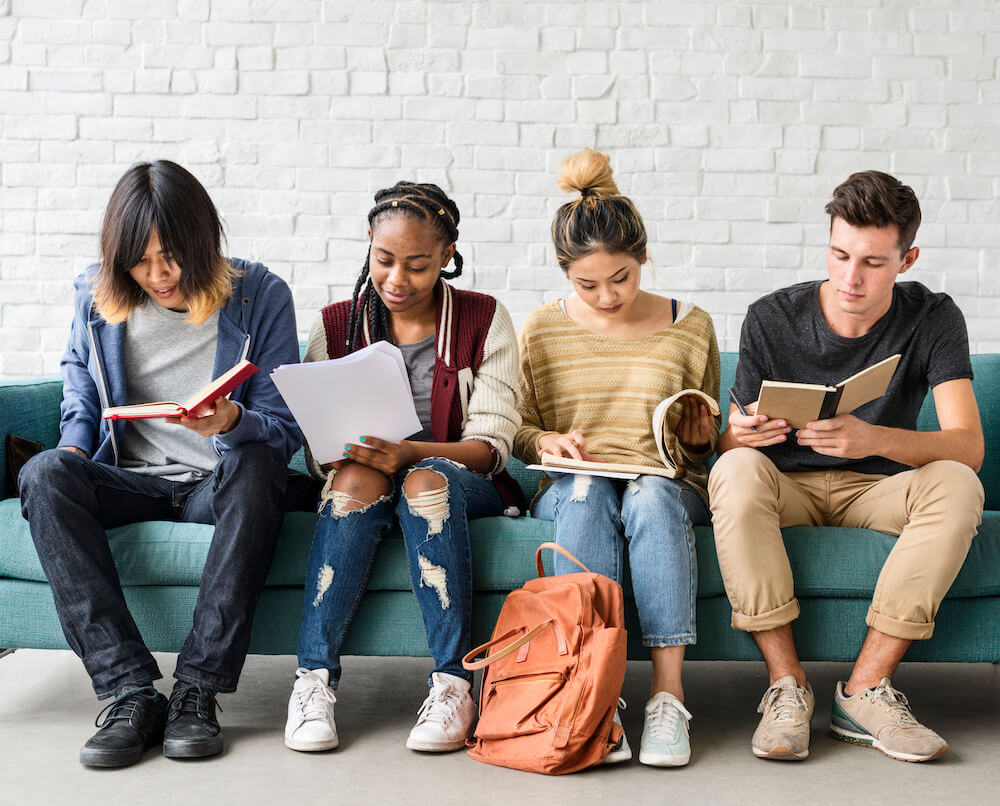 A diverse set of teens working on school work together