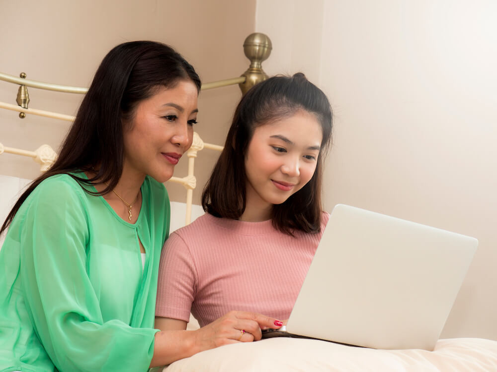 Mother and daughter are using computer