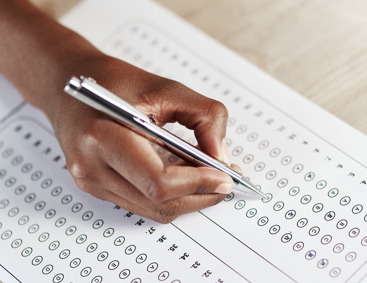 Happy graduate student with a certificate after graduation ceremony at the university.