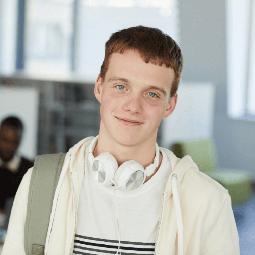 Portrait Of Female High School Student Standing outside of a high school