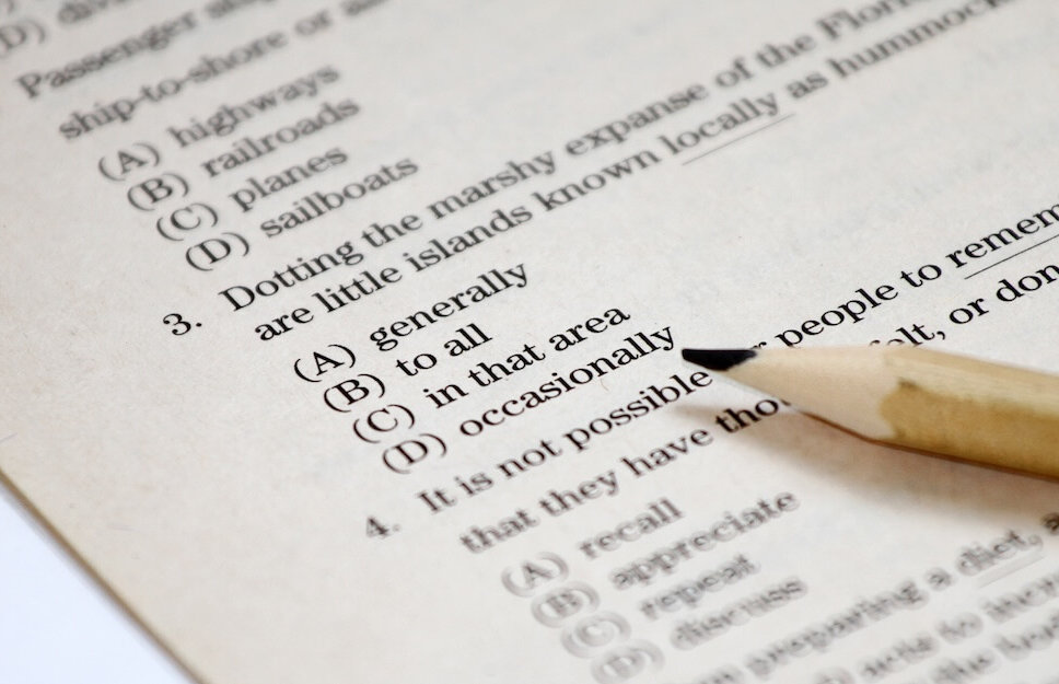 Close-up of an SAT multiple choice question sheet with pencil, referencing May 3, 2025 SAT score release dates.
