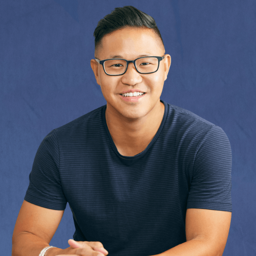 Chris Rim, CEO and Founder, in a navy blue shirt, sitting casually with his hands clasped, in front of a neutral background