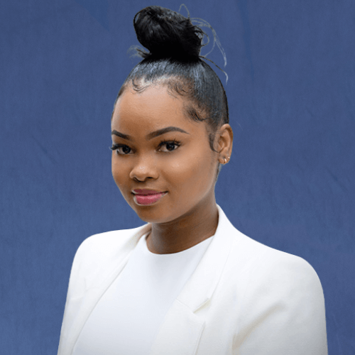 Dennesha, Senior Operations Manager, n a formal white blazer with a high bun hairstyle and light makeup