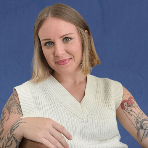 Emily, Content Strategist, wearing a cream-colored sleeveless knit sweater