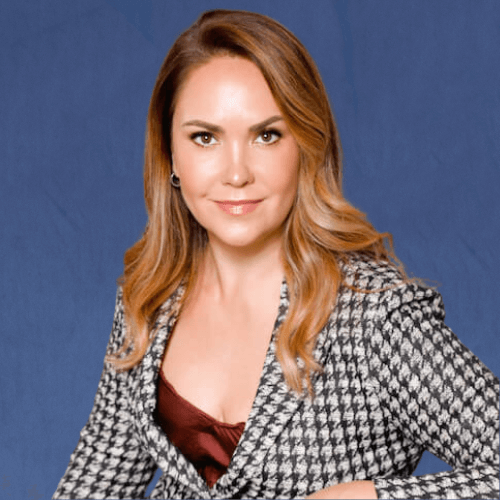 Roberta Seiler, Partner & COO, wearing a houndstooth blazer over a burgundy satin top, sits in a stylish modern room 