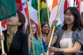 International Students on a college campus holding their country's flag as a representation of themselves